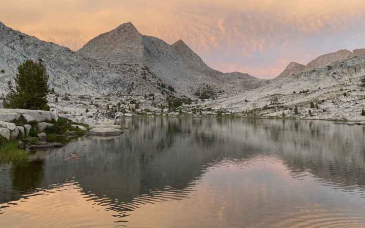 mountains are reflected in a body of water in the sierra nevada range